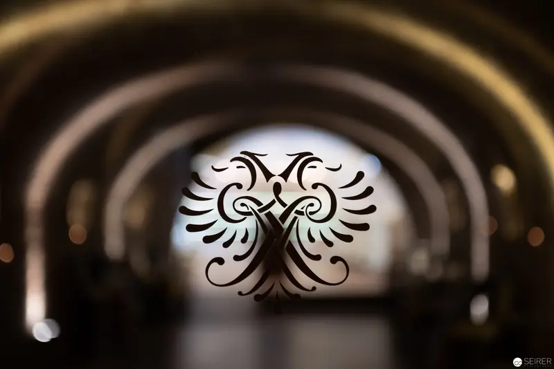 Symmetrical Tribal Emblem Framed by Arched Architecture and Soft Light
