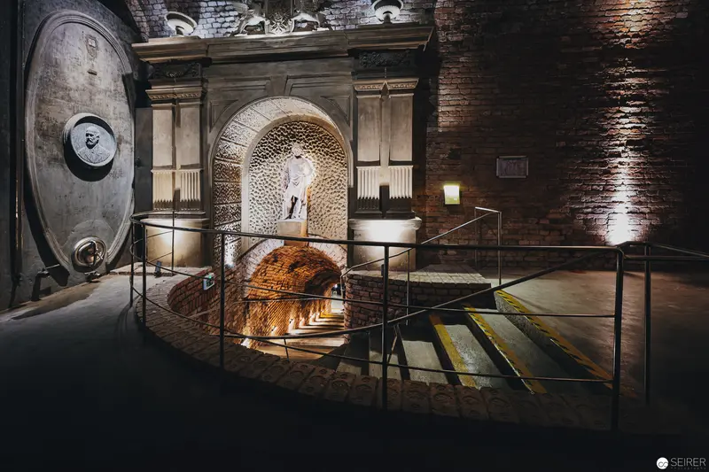 Industrial Archival Space with Brick Walls and Illuminated Tunnel Passage