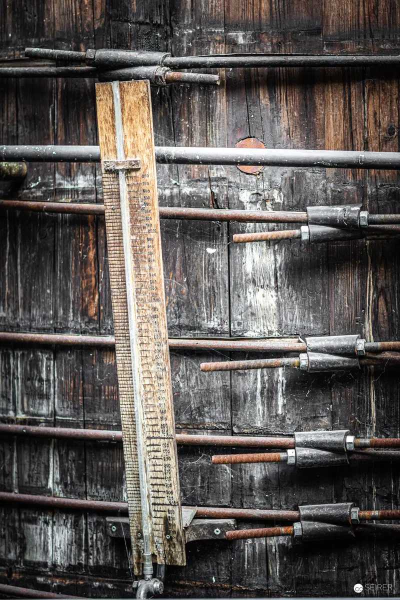 Industrial Measurement: Vintage Wooden Ruler Against Weathered Barn Wall Texture