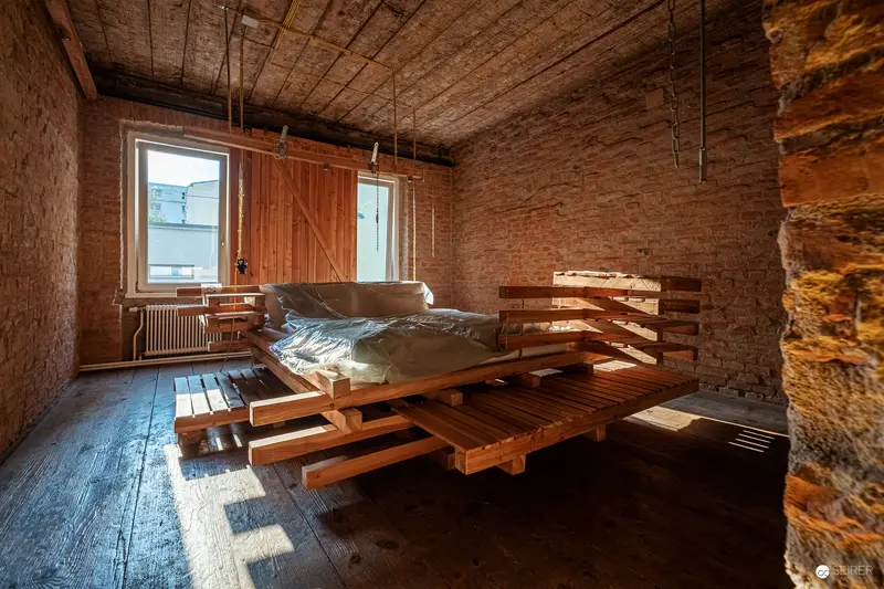 Minimalist Wooden Bedroom Interior with Exposed Brick and Custom Platform Bed