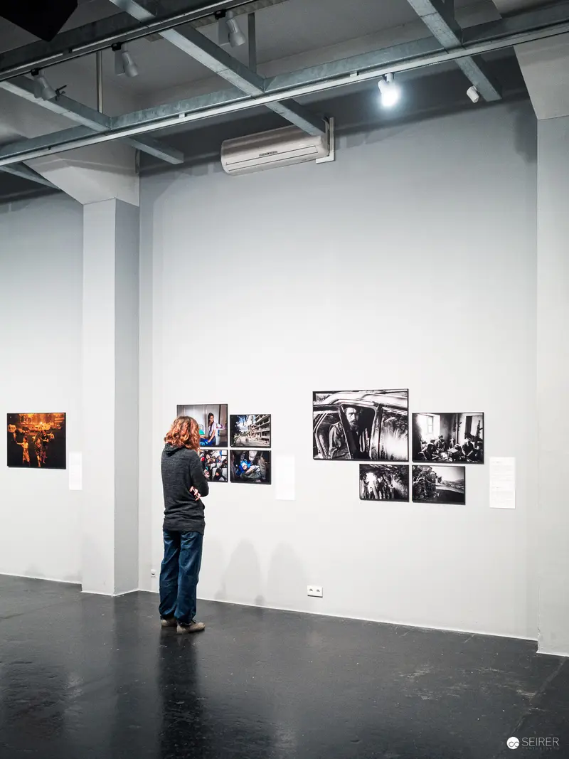 Gallery Visitor Studying Photographic Exhibition of Black and White Images