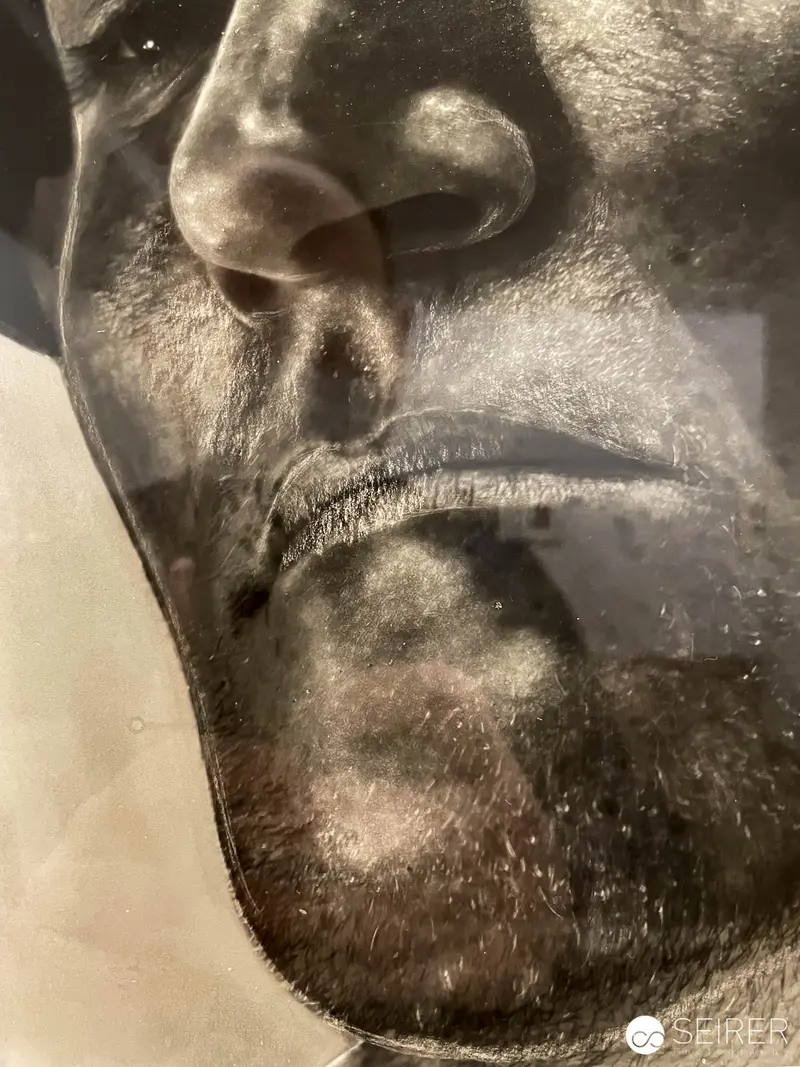 Intimate Monochrome Portrait of Textured Facial Contours in "Faces" Exhibition