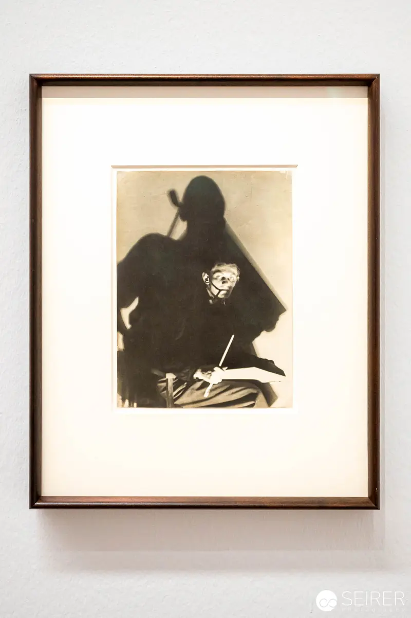 Shadowed Portrait of Contemplative Figure in Sepia Tones