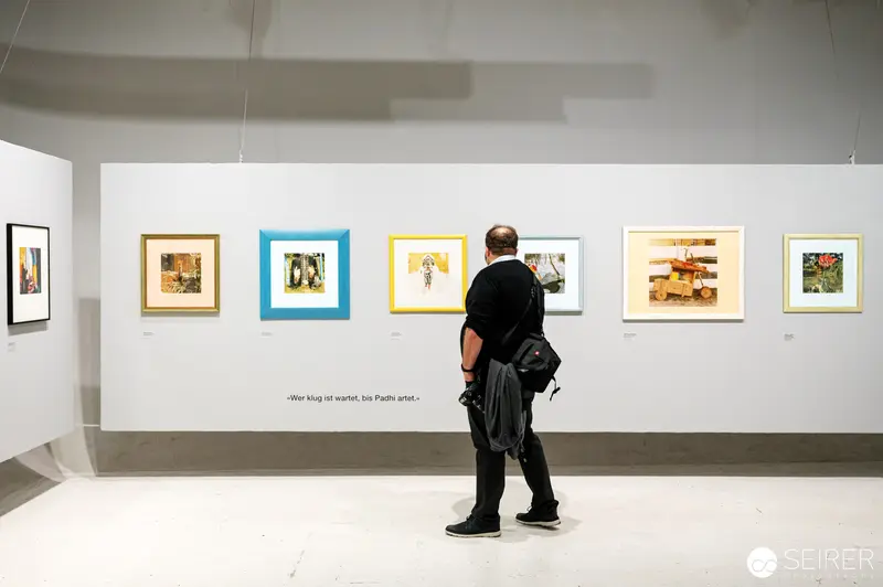 Solitary Viewer Contemplates Padhi Frieberger's Photographic Works at Westlicht