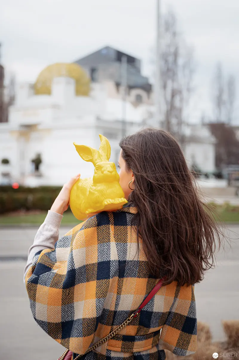 Woman in Yellow and Plaid Contemplating Urban Landscape
