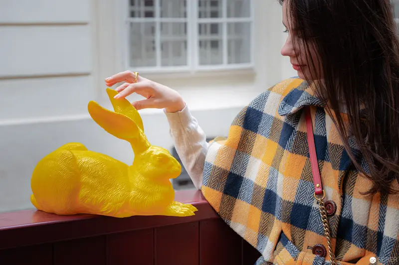 Contemplative Encounter with Yellow Ceramic Hare Sculpture