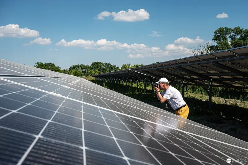 Solar Technician Conducting Inspection at Photovoltaic Array Installation Site