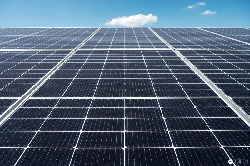 Grid of Photovoltaic Solar Panels Capturing Renewable Energy Against Blue Sky