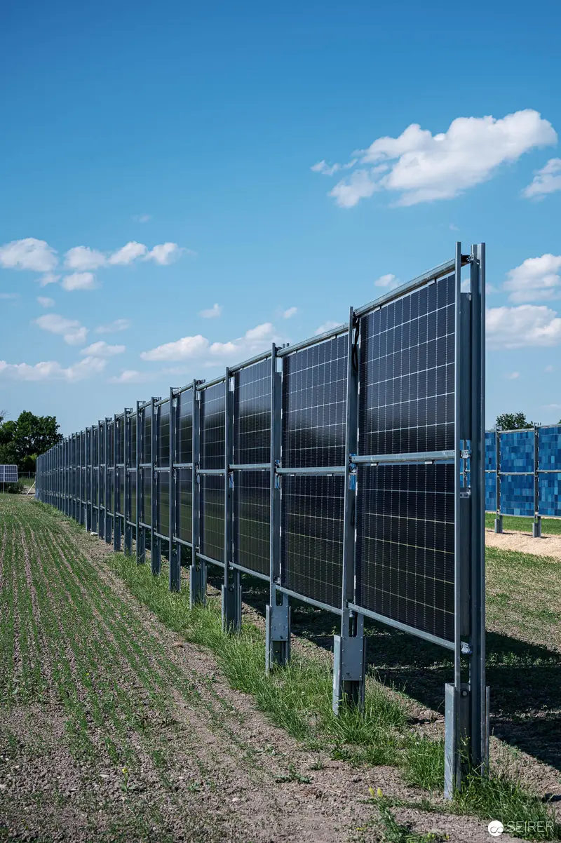 Expansive Solar Panel Array in Agricultural Landscape with Cloudscape