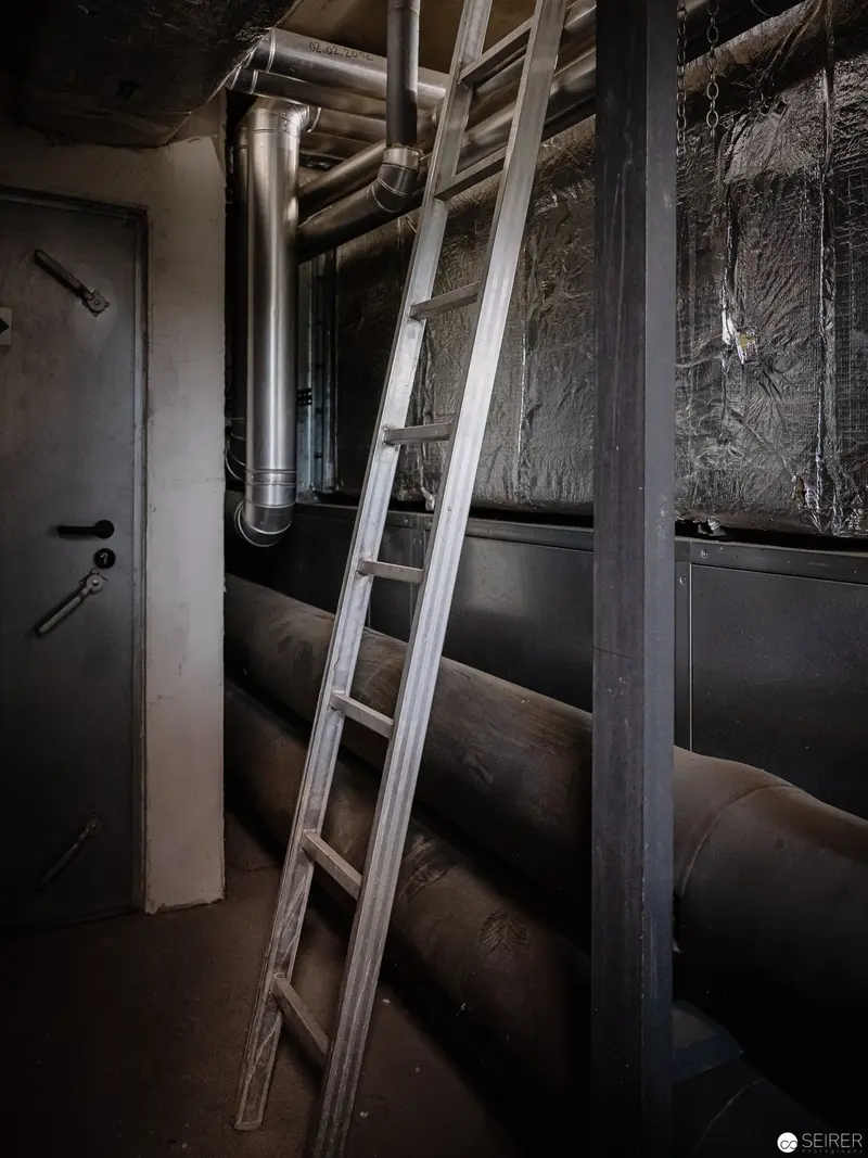 Industrial Utility Corridor with Metallic Ladder and Exposed Piping