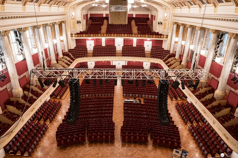 Interior of Historic Vienna Concert Hall with Ornate Red and White Auditorium