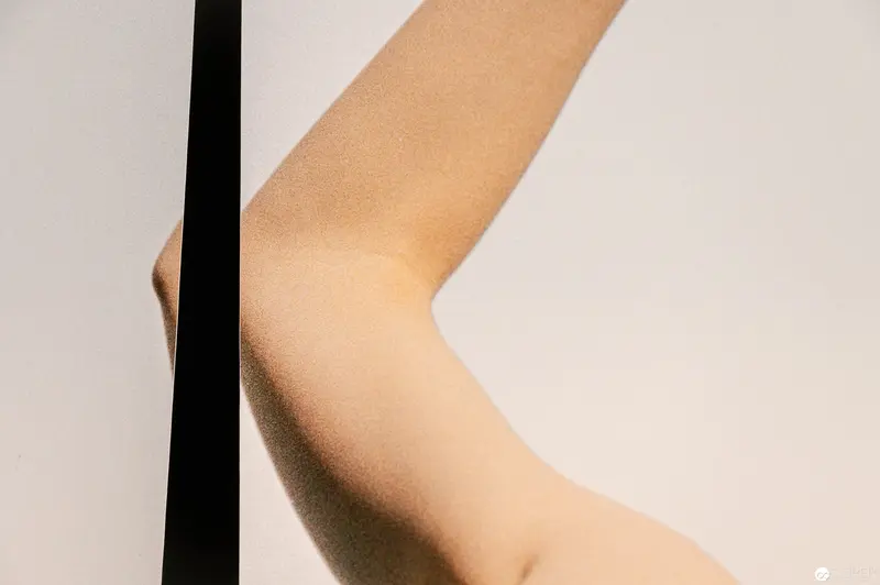 Minimalist Bodily Geometry: Cropped Limb in Neutral Palette