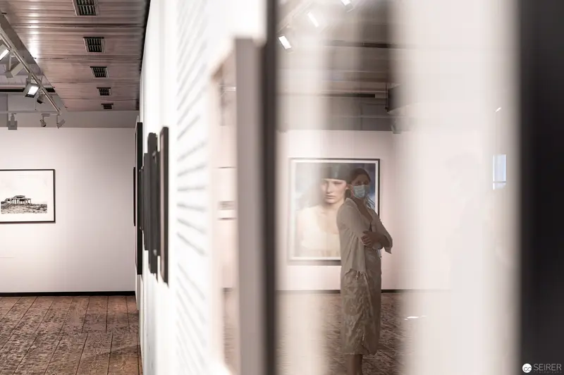 Elfie Semotan Exhibition View: Framed Portrait through Gallery Partition