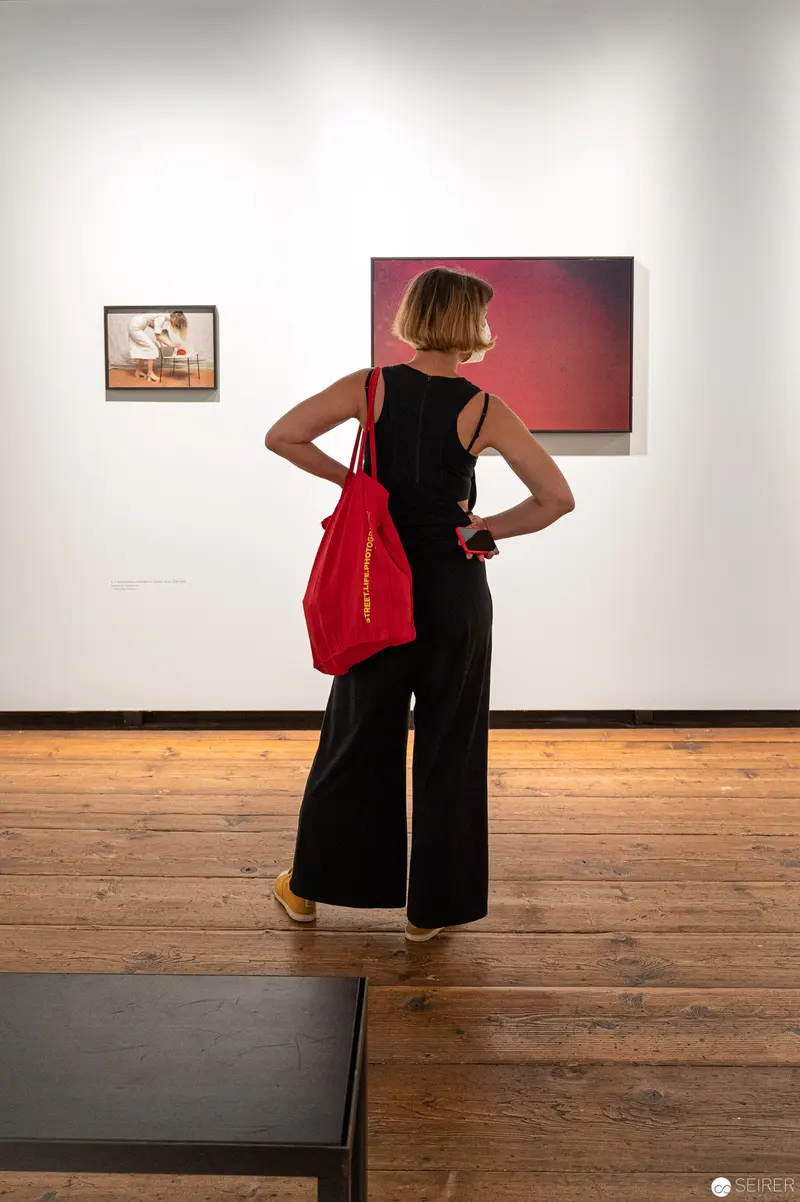 Elfie Semotan Exhibition View: Visitor in Black and Red at Kunsthaus Wien
