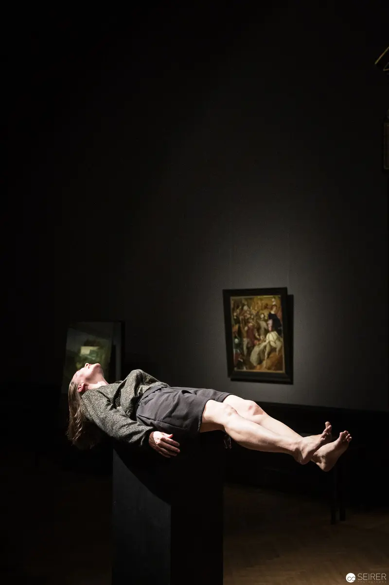 Levitating Figure Suspended in Dark Museum Gallery with Classical Painting