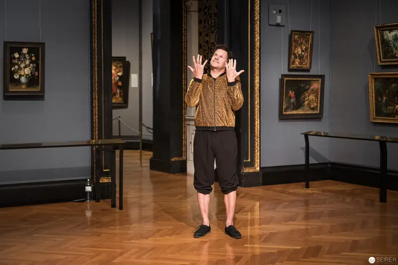 Performance Ganymed at Kunsthistorisches Museum Wien: Gestural Performer in Golden Jacket