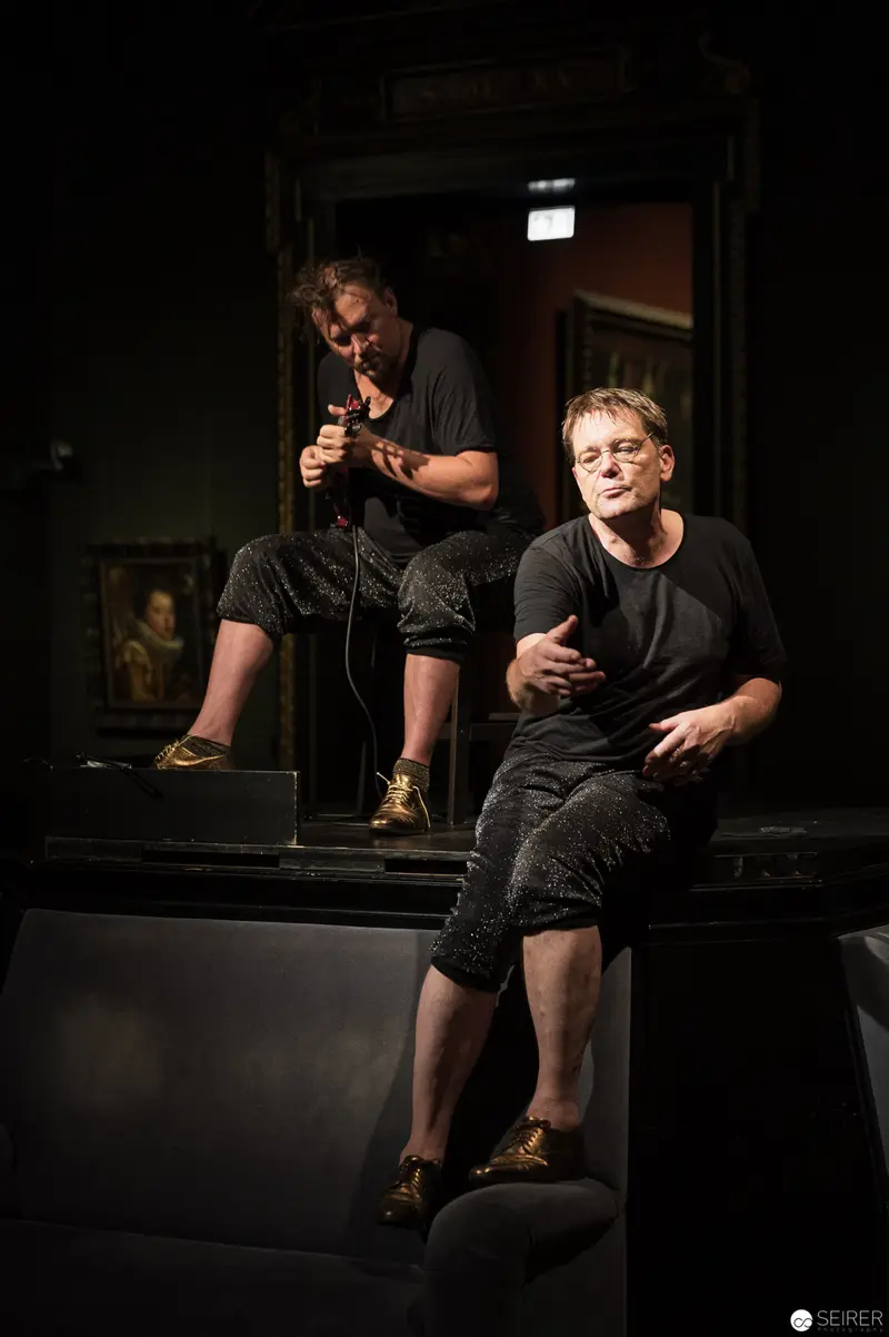 Performance Ganymed: Two Actors in Dark Minimalist Theatrical Space