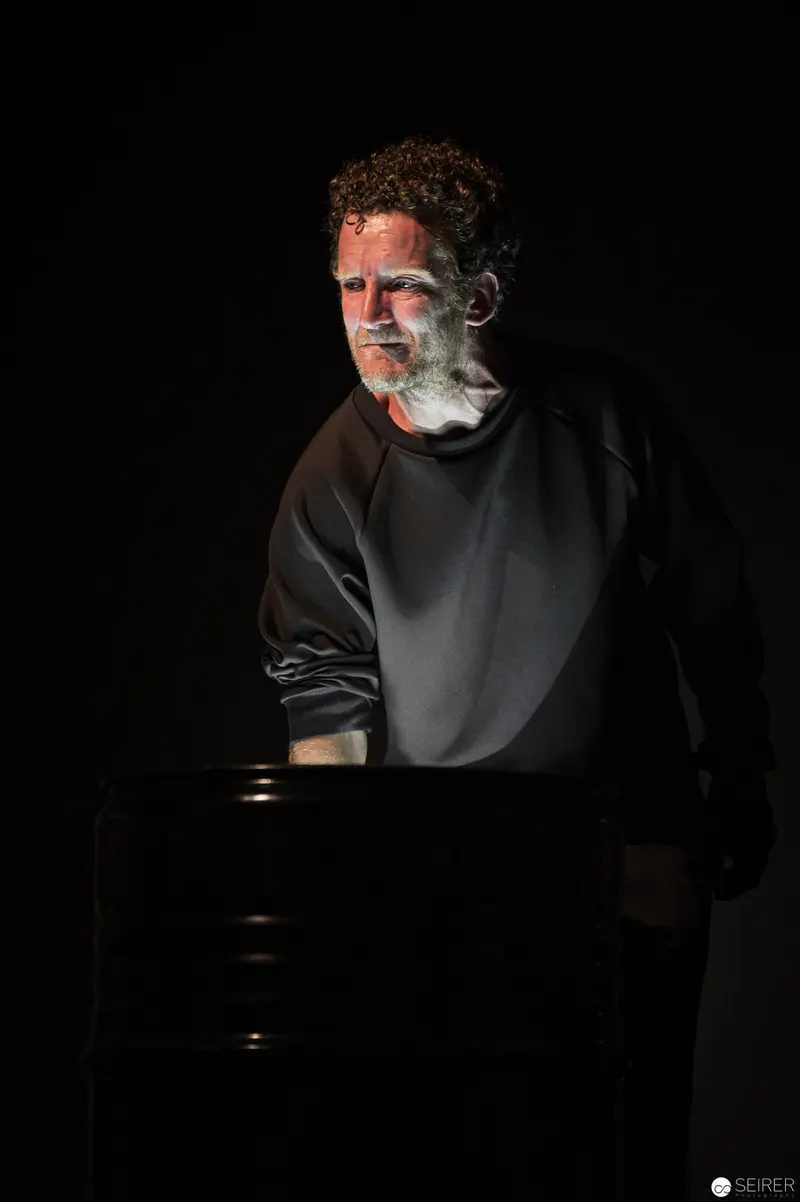Dramatic Low-Key Portrait of a Contemplative Figure at Performance Ganymed