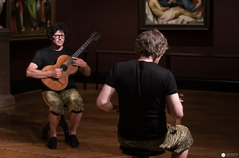 Performance Ganymed: Guitarist in Introspective Pose at Kunsthistorisches Museum Wien