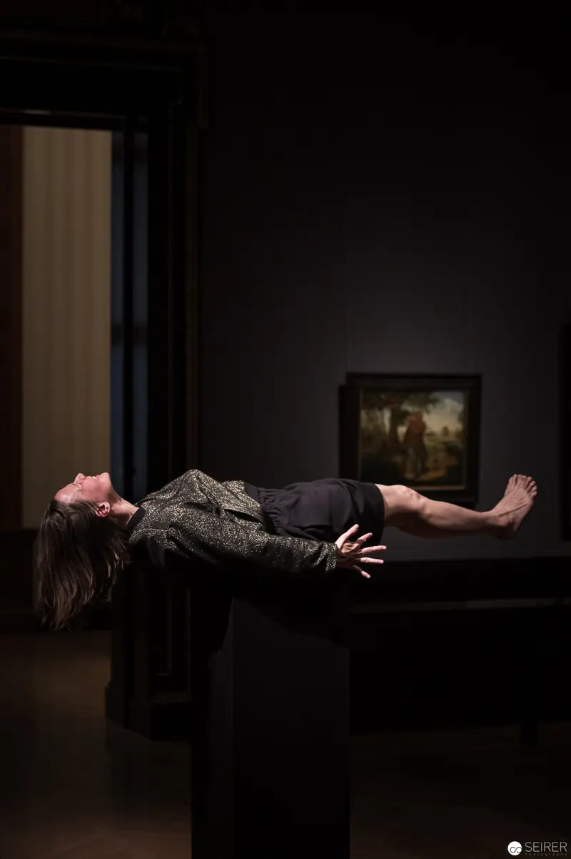 Levitating Figure in Dark Museum Space during Performance Ganymed
