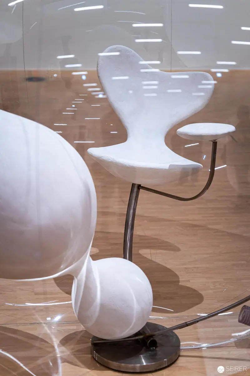 White Sculptural Chairs and Spherical Forms in Minimalist Interior