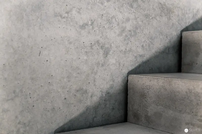 Minimalist Concrete Staircase with Angular Shadow Composition