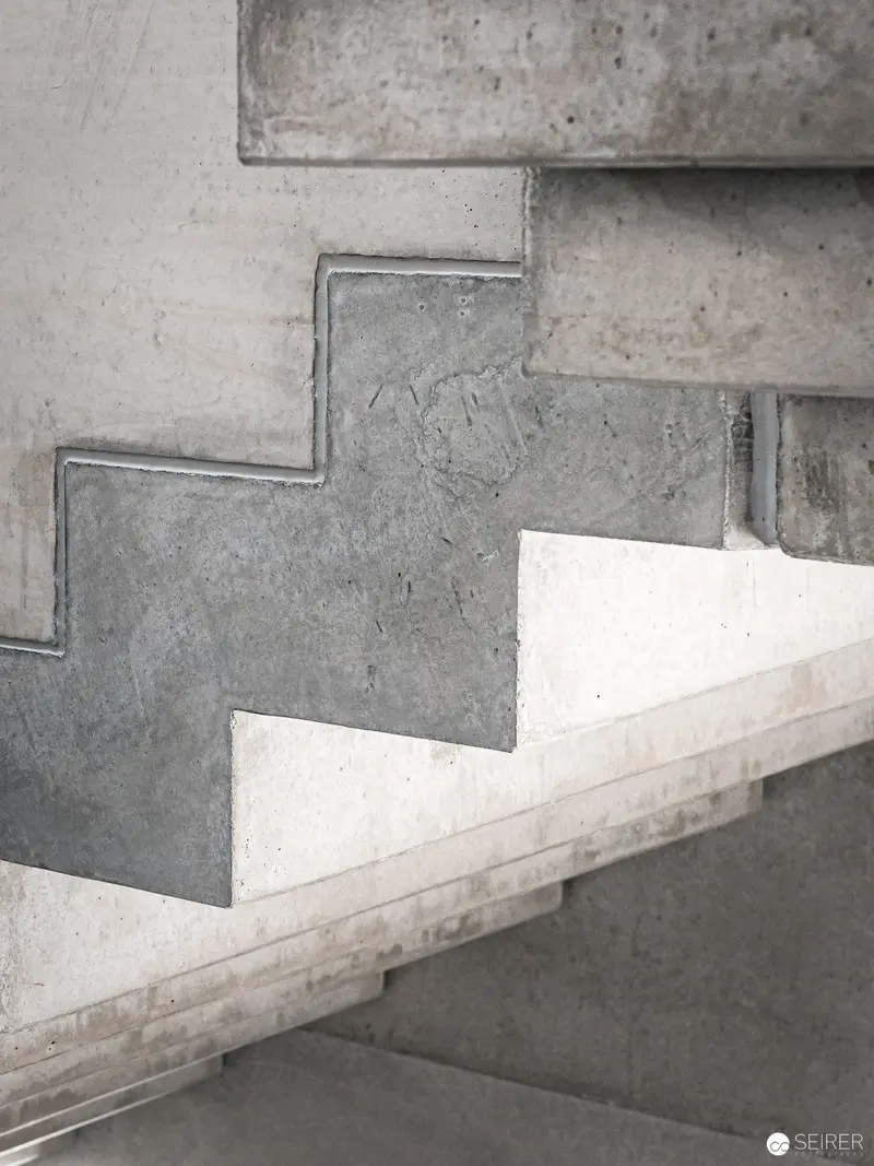 Minimalist Concrete Staircase with Geometric Zigzag Structural Transition