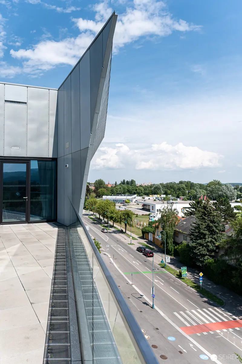 Contemporary Architecture with Dramatic Angular Facade Overlooking Urban Street Scene