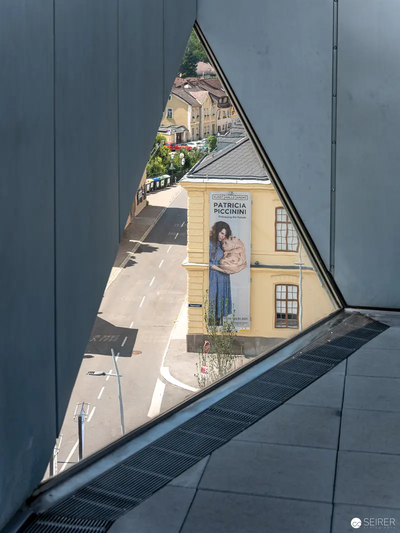 Triangular Window View of Yellow Building and Urban Streetscape