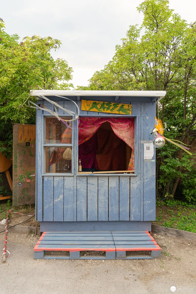 Blue Wooden Booth with Red Interior at Outdoor Location