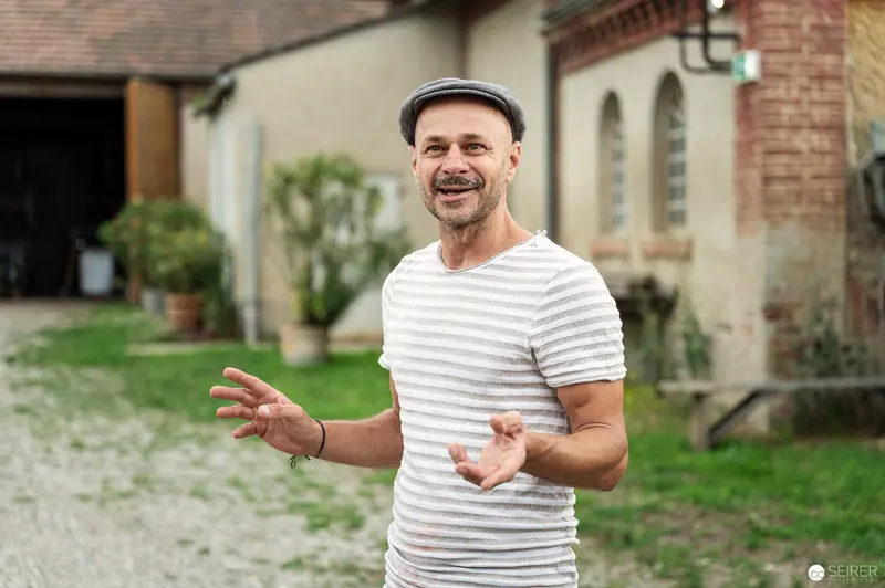 Smiling Man in Striped Shirt at Rothneusiedl Farmstead