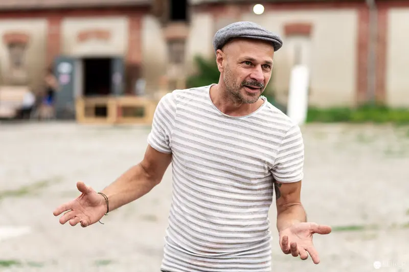 Middle-Aged Man in Striped Shirt and Flat Cap at Rothneusiedl Future Farm
