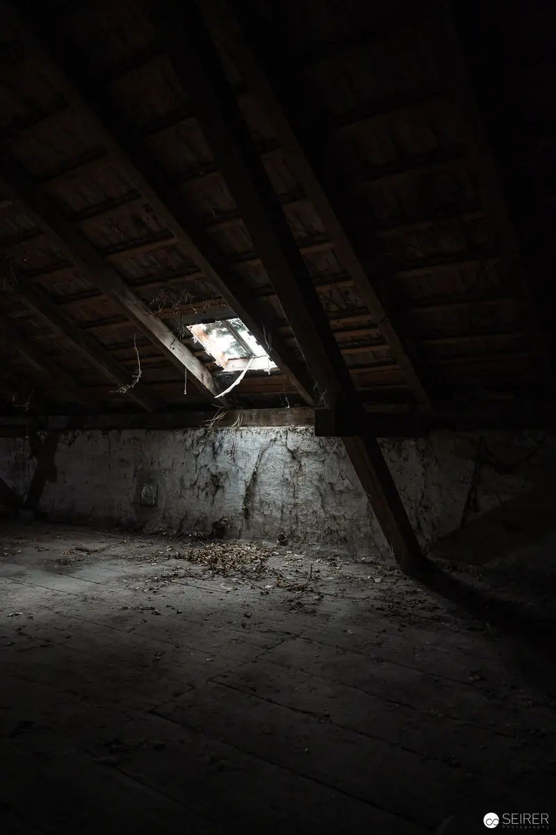 Abandoned Attic: Solitary Light Through Broken Window