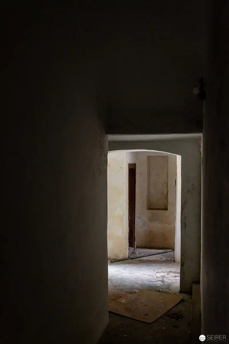 Liminal Passage: Interior Architecture Through Shadowed Doorway