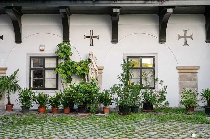 Baroque Courtyard with Religious Statuary and Potted Greenery