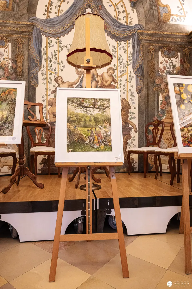 Framed Artwork on Wooden Easel in Ornate Deutschordenshaus Interior