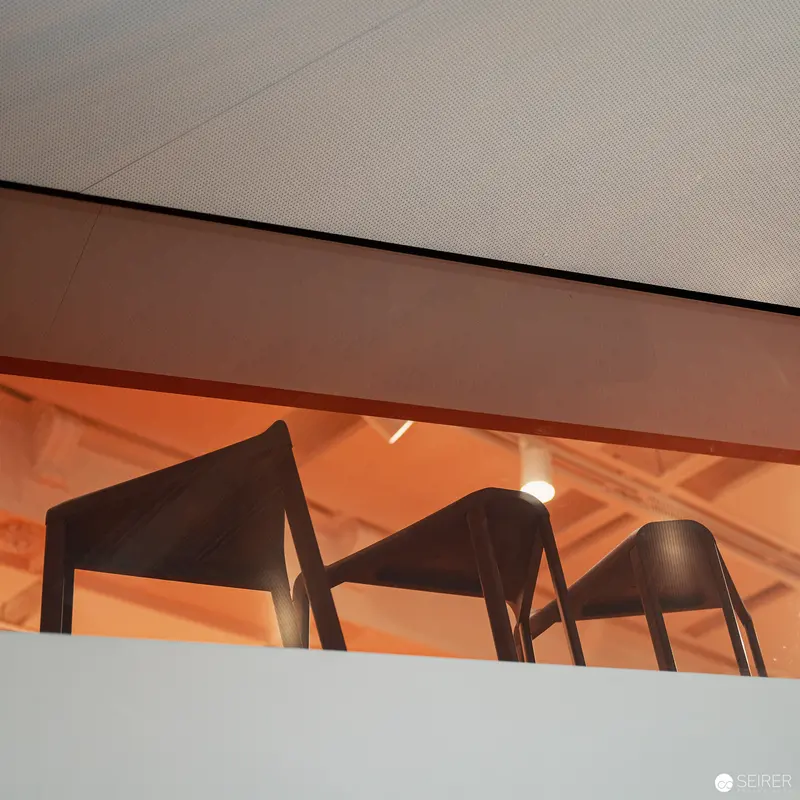 Minimalist Chairs Casting Geometric Shadows in Warm Interior Space