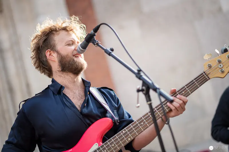 Bass Guitarist Performs with Intense Energy at Musik Befreit Abschlusskonzert