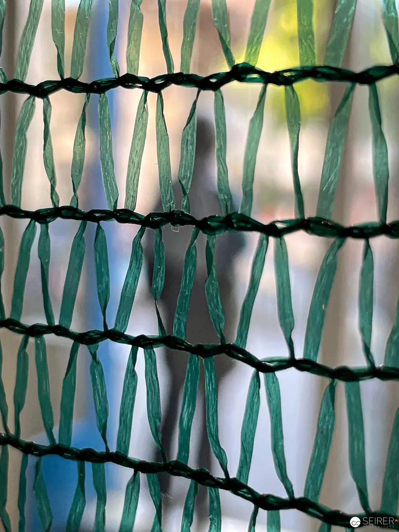 Intricate Green Mesh Textile Abstraction with Woven Structural Patterns