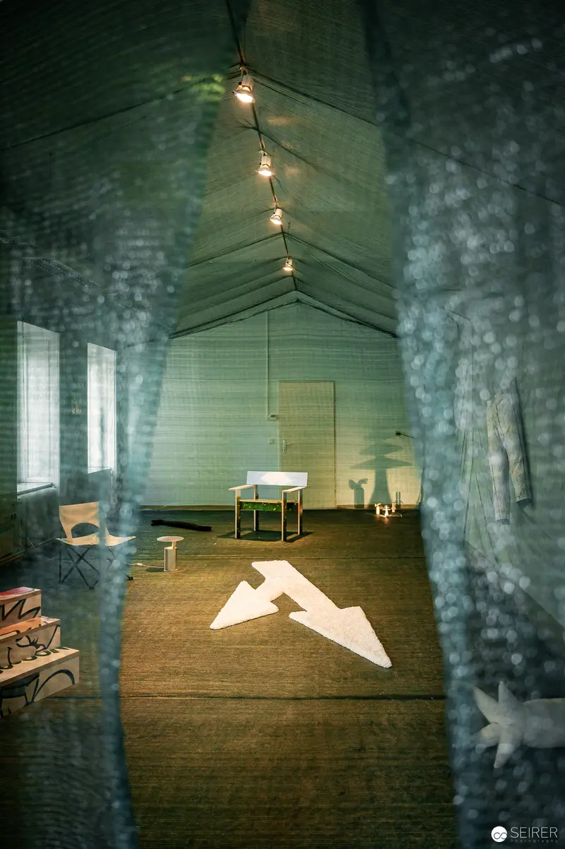 Minimal Interior Space with Paper Airplane Projection at Vienna Design Week