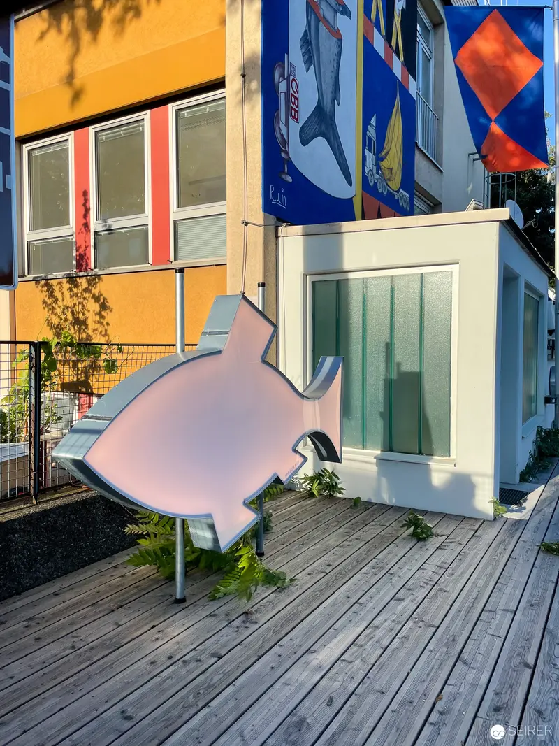 Pink Fish-Shaped Sculpture on Wooden Deck During Vienna Design Week