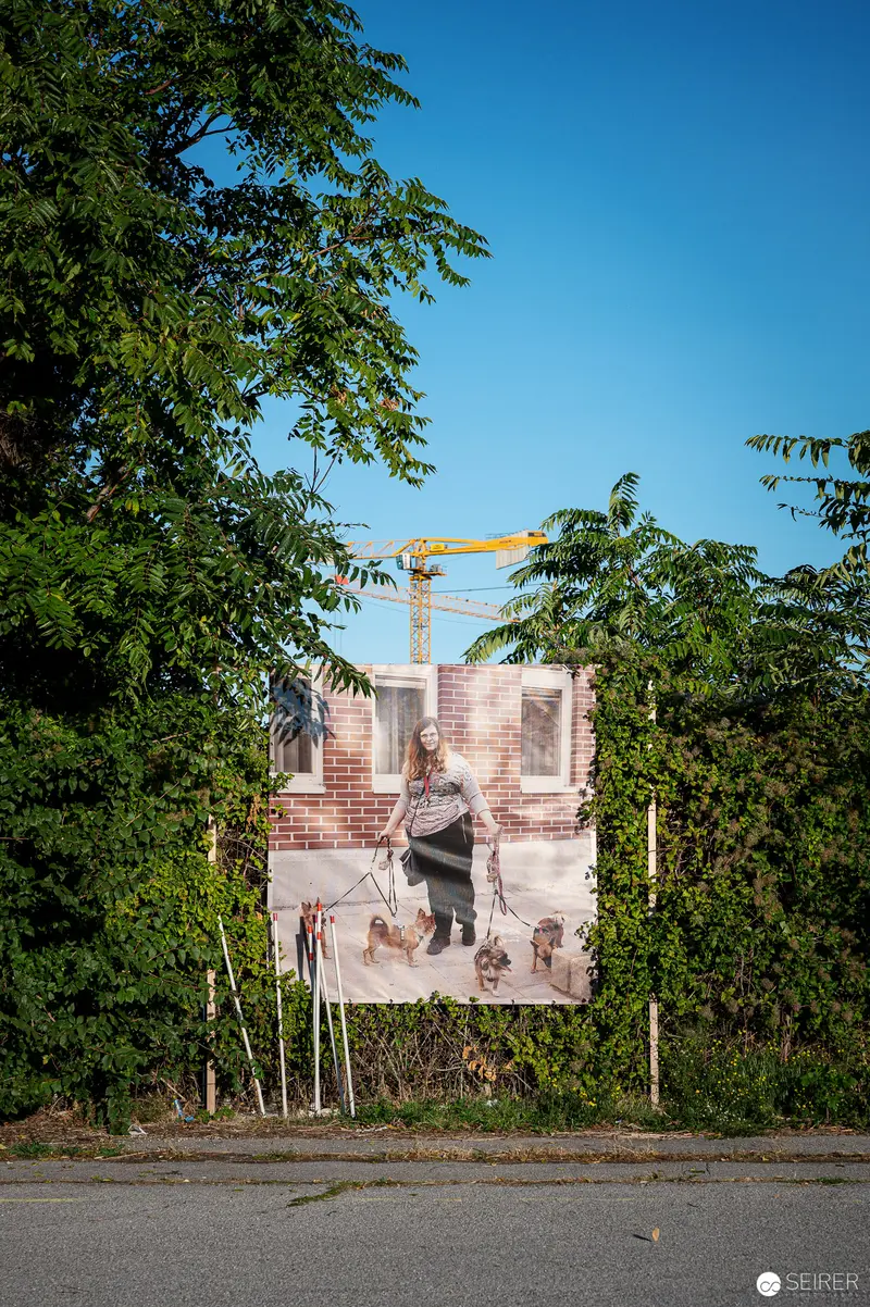 Urban Street Art Poster Emerging from Lush Greenery Near Construction Site