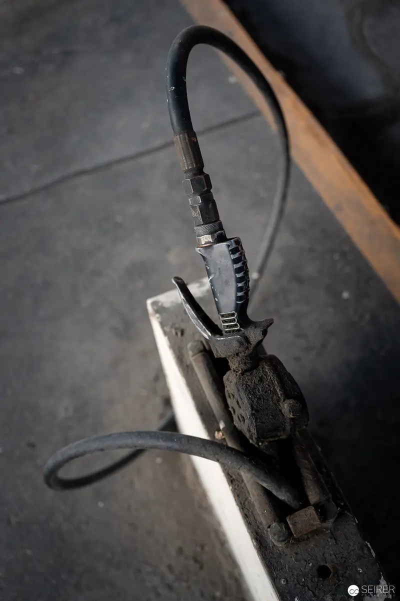 Worn Electrical Clamp and Cable in Monochromatic Industrial Setting