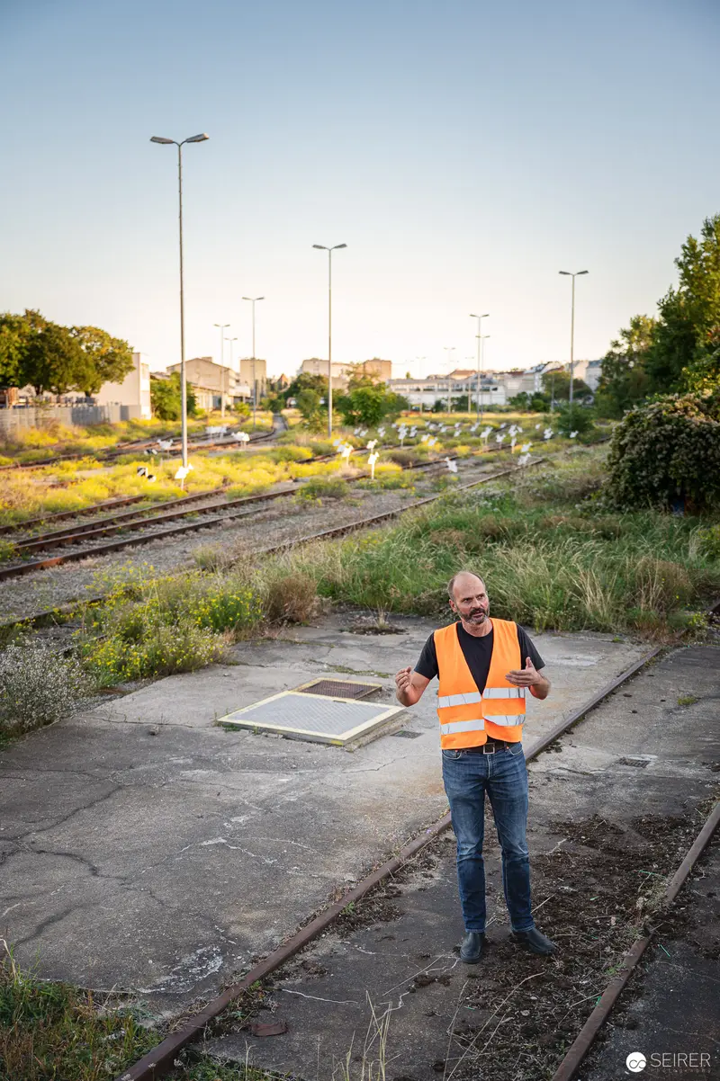Vienna Design Week IgersWalk: Worker in Safety Vest Amid Abandoned Railway Tracks