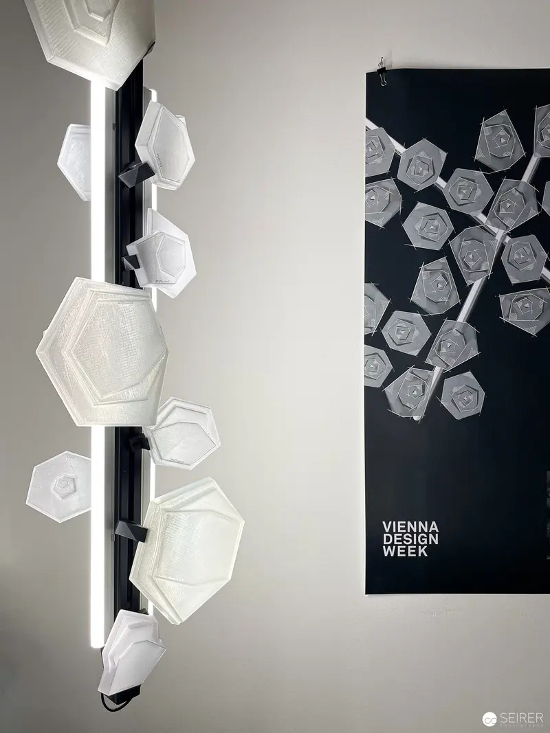 Vienna Design Week Geometric Installation: White Hexagonal Forms on Black Background