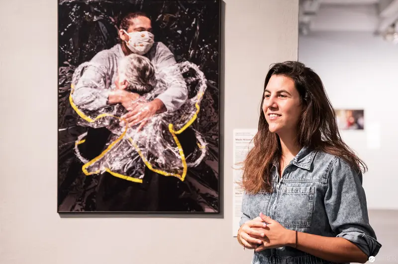 Pandemic Embrace: Protective Gesture at World Press Photo Exhibition