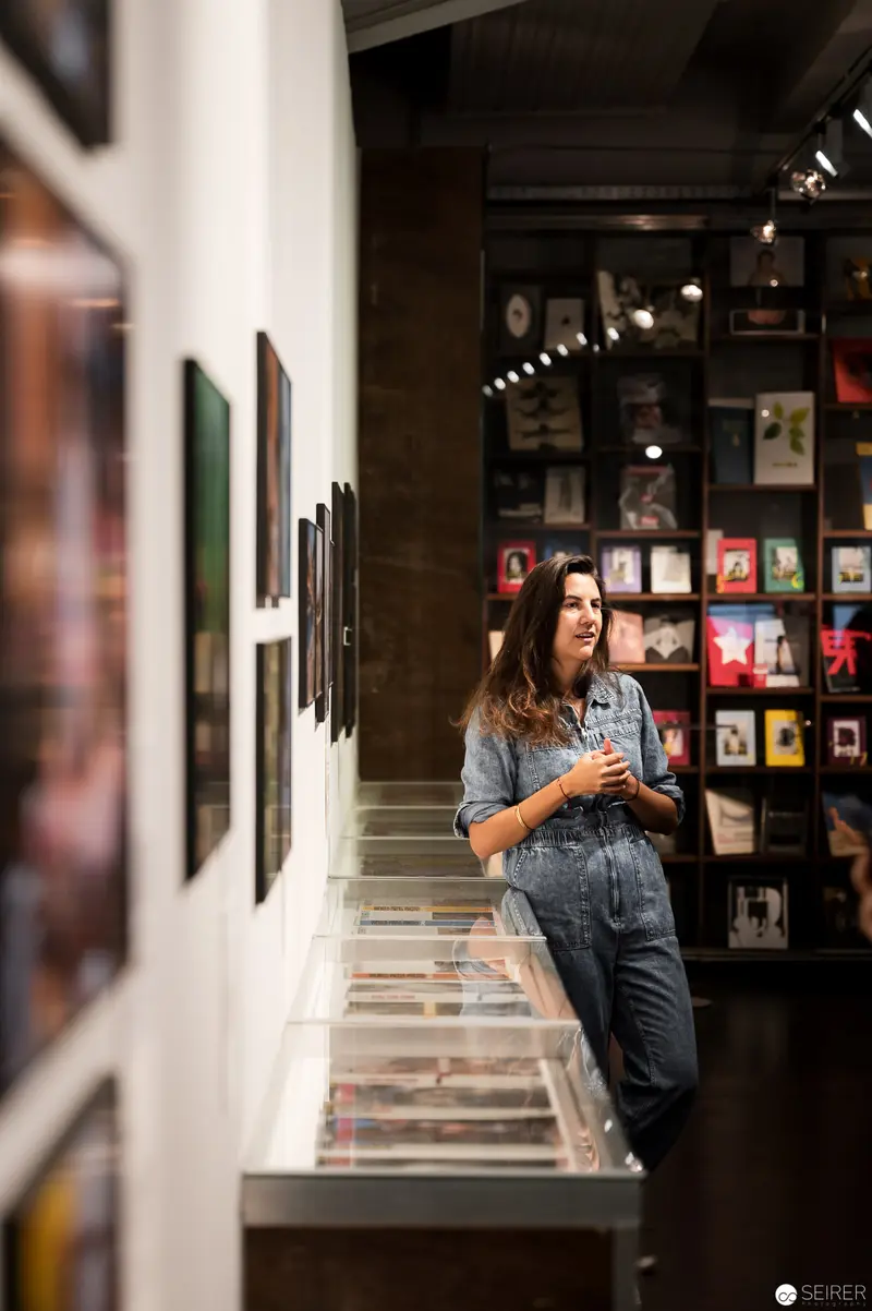 Woman Contemplating Art Collection in World Press Photo Exhibition Space