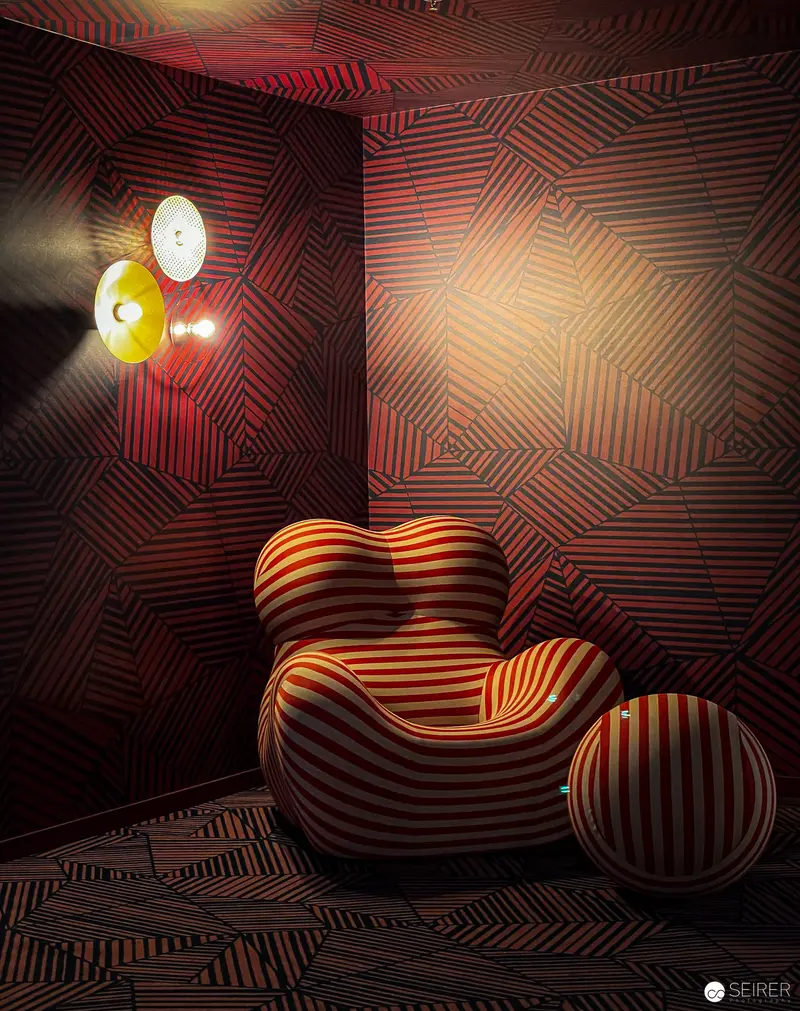 Striped Modernist Chair with Sculptural Form in Dramatic Lighting