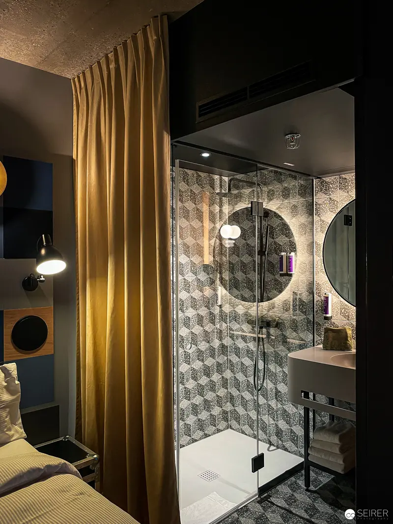 Intimate Hotel Jaz Rooftop Bar Interior with Dramatic Shower and Curtain Composition