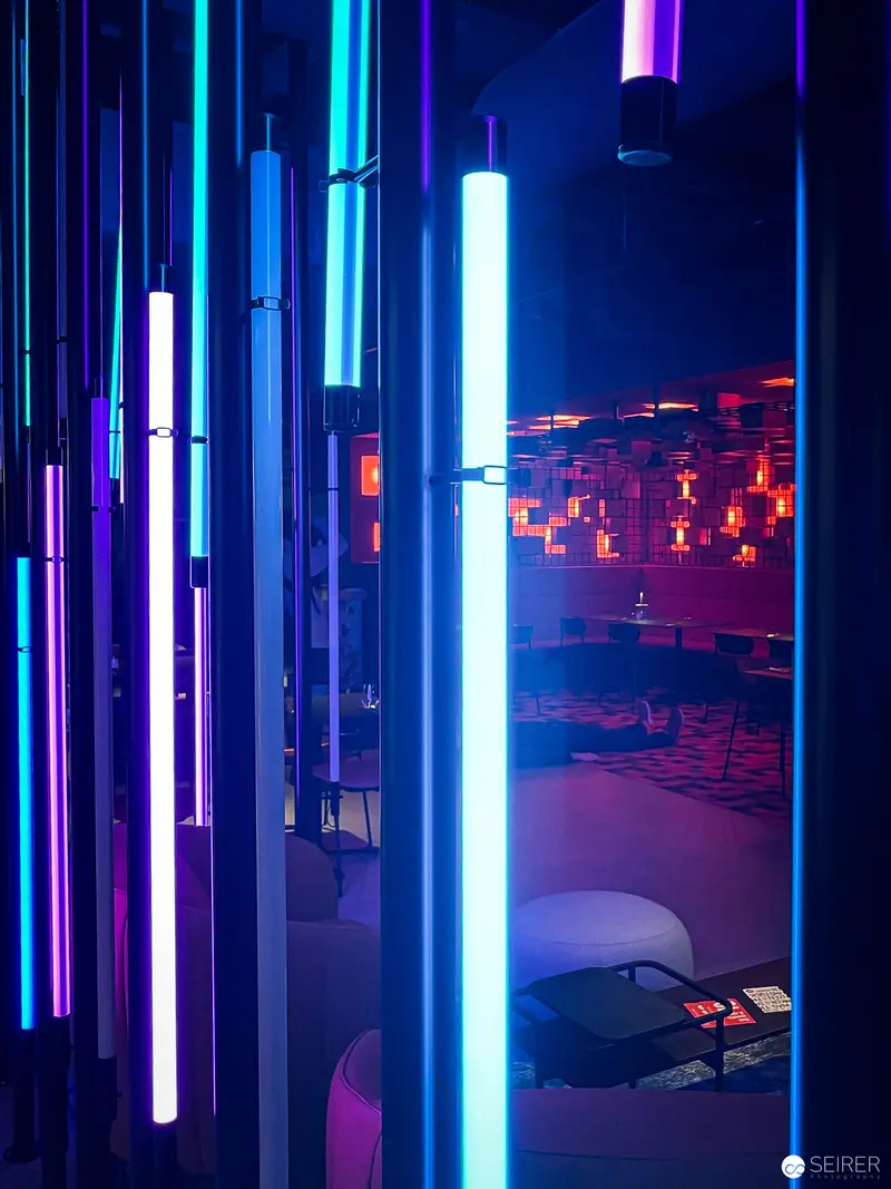 Neon Vertical Light Bars Framing Cyberpunk Urban Night Scene